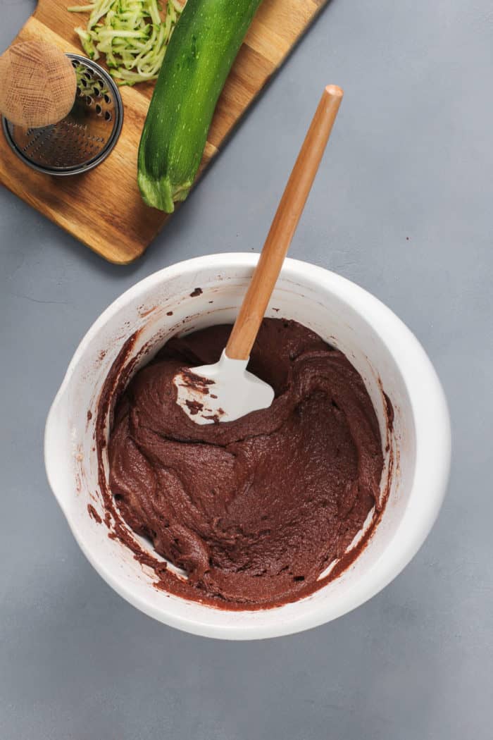 Chocolate cake batter base for chocolate zucchini cake in a white mixing bowl.