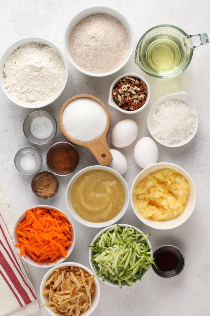 Ingredients for morning glory muffins arranged on a white countertop.