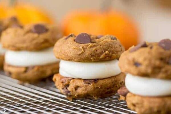 Pumpkin Whoopie Pies are made with fluffy pumpkin chocolate chip cookies and cream cheese filling to create a delicious sandwich cookie.