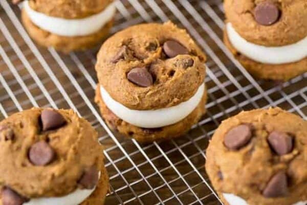 Pumpkin Whoopie Pies are made with soft pumpkin chocolate chip cookies and cream cheese filling to a festive fall sandwich cookie.