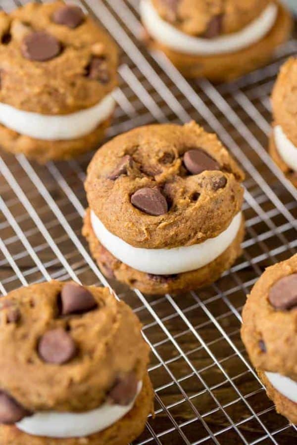 Pumpkin Whoopie Pies are made with fluffy pumpkin chocolate chip cookies and a delicious cream cheese filling to create the perfect dessert for fall.