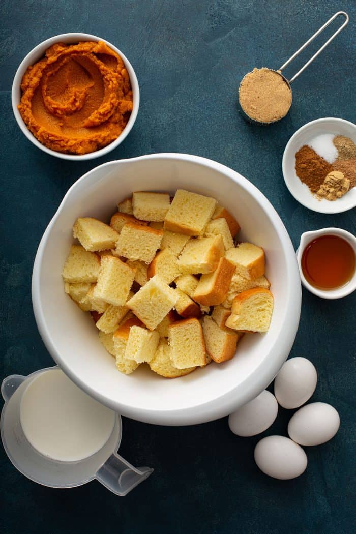 Ingredients for pumpkin bread pudding on a countertop