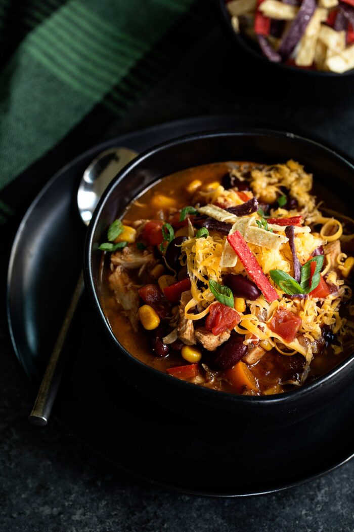 Easy Chicken Chili is so simple! Rotisserie chicken, tomatoes, corn, and beans are simmered with your favorite chili spices for a total win at dinner time.