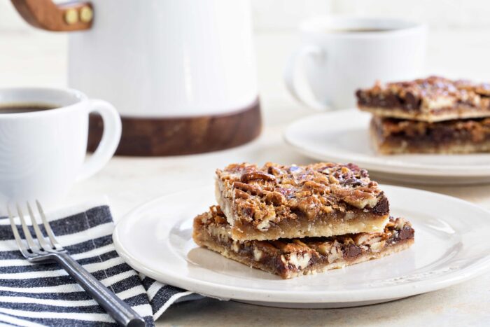 Chocolate Bourbon Pecan Bars are a fun twist on classic pecan pie. This recipe makes 48 bars, so it's perfect for the holidays!