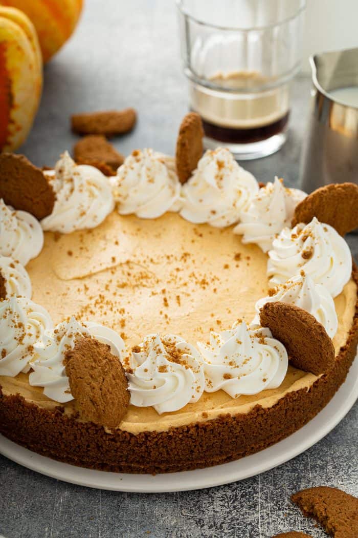 Assembled marshmallow pumpkin pie garnished with whipped cream and gingersnap cookies