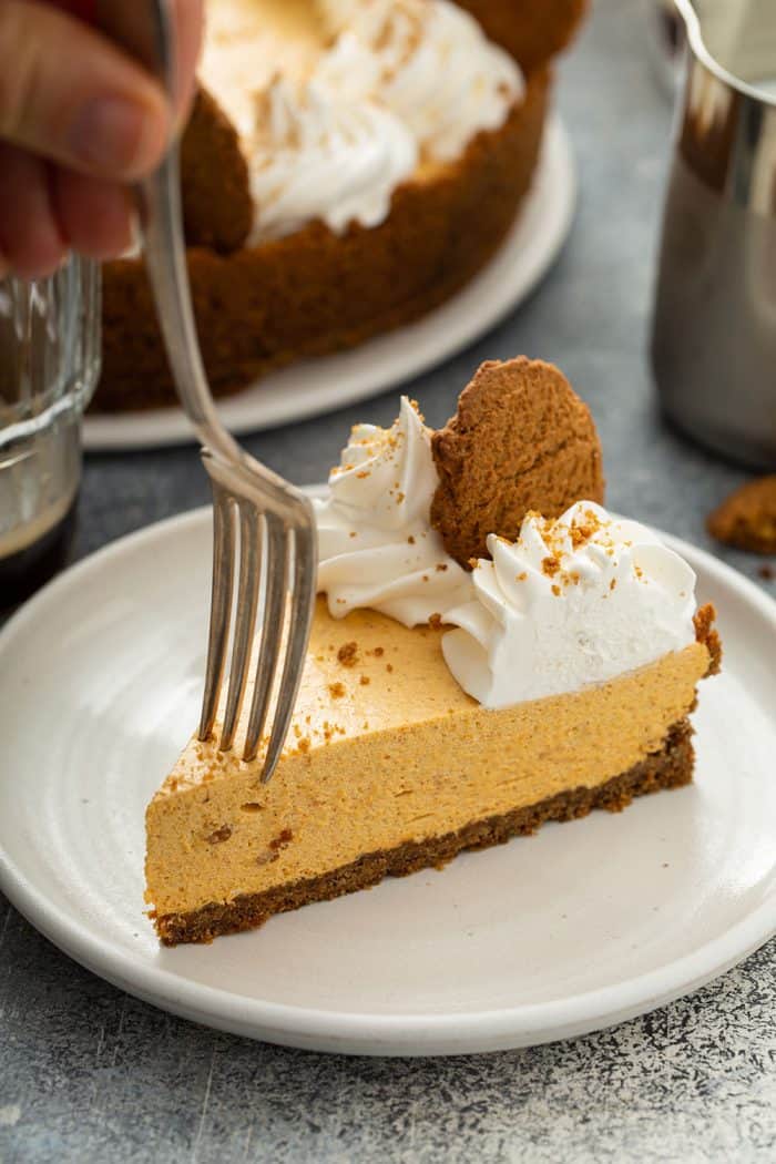 Fork about to take a bite of a slice of marshmallow pumpkin pie