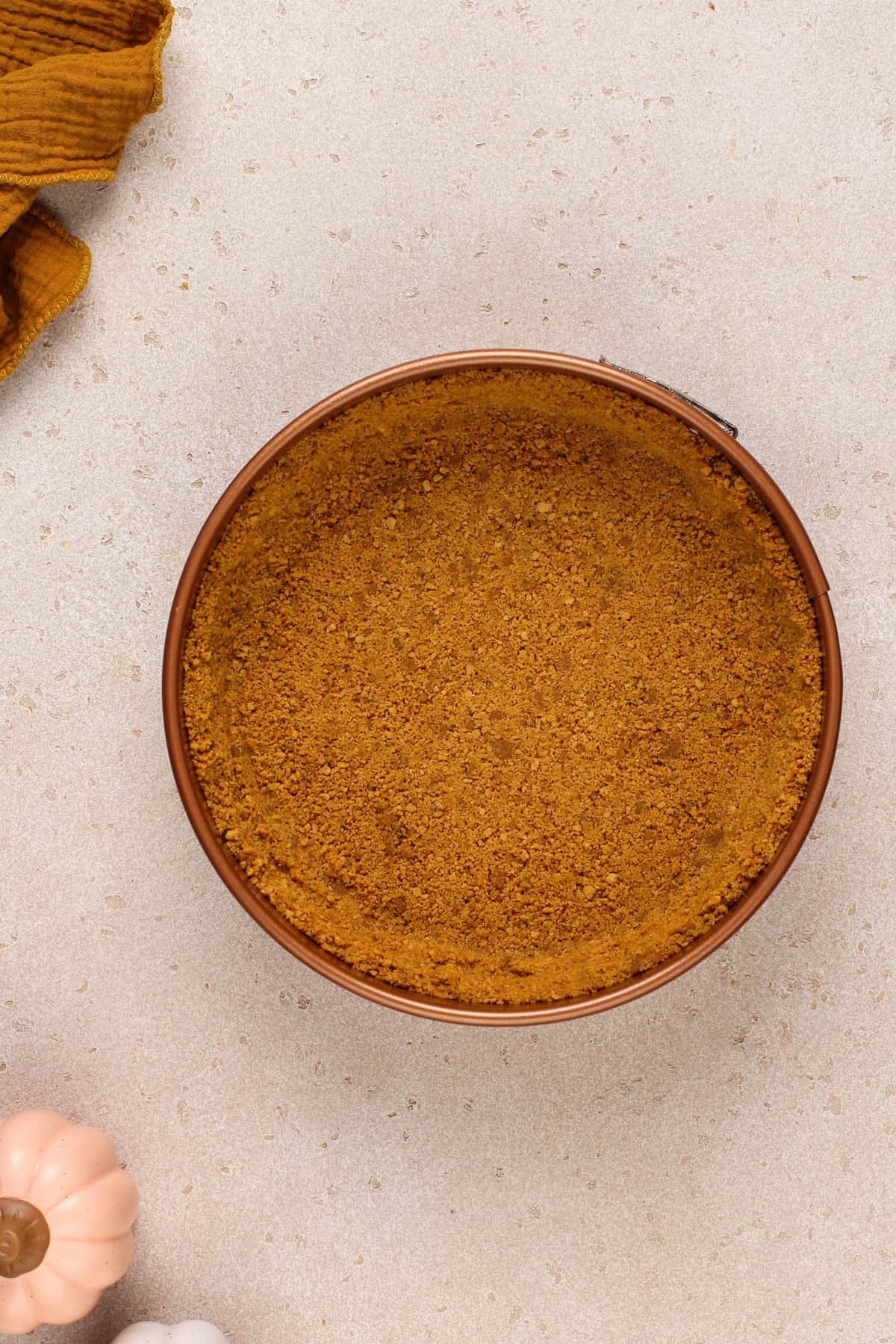 Gingersnap crust in a springform pan.