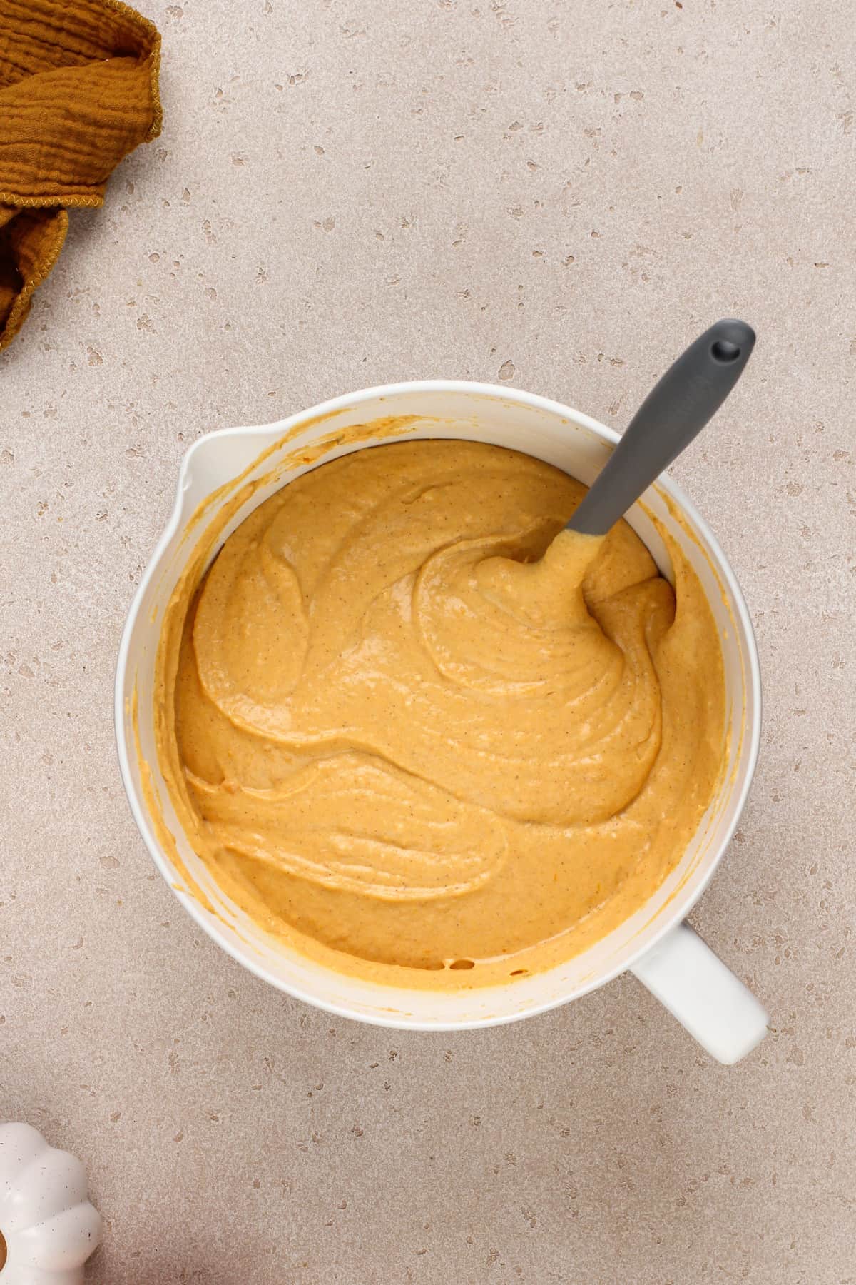 Sweet potato cheesecake filling in a white mixing bowl.