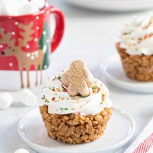 Gingerbread Marshmallow Treat Cupcakes are an adorable and delicious addition to any holiday dessert plate! Festive sprinkles make and mini gingerbread marshmallows make them merry and bright