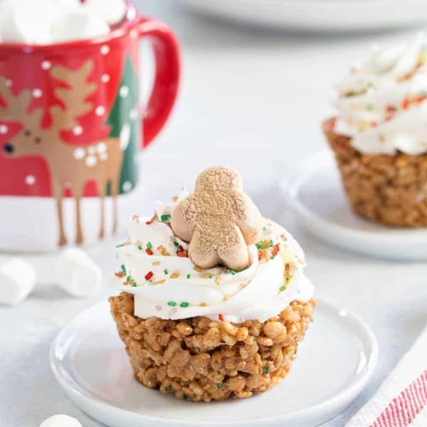 Gingerbread Marshmallow Treat Cupcakes are an adorable and delicious addition to any holiday dessert plate! Festive sprinkles make and mini gingerbread marshmallows make them merry and bright