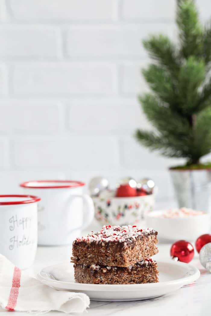 Chocolate Peppermint Scotcheroos are a fun and festive spin on a classic no-bake dessert. Chocolate hazelnut spread, dark chocolate chips, and crushed candy canes make them extra special!