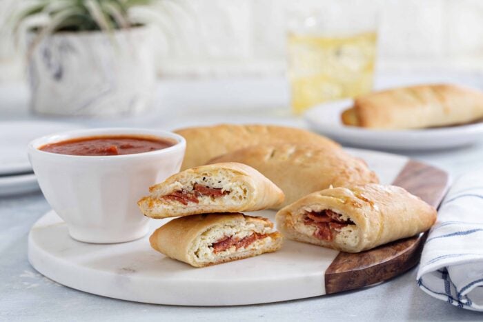 Easy Pizza Pockets come together with ease and are totally delish. Load them up with your favorite pizza toppings for the perfect game day appetizer.