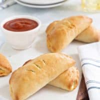 Easy Pizza Pockets come together quikly and are totally delish. Fill them with your favorite pizza toppings for the perfect game day snack!