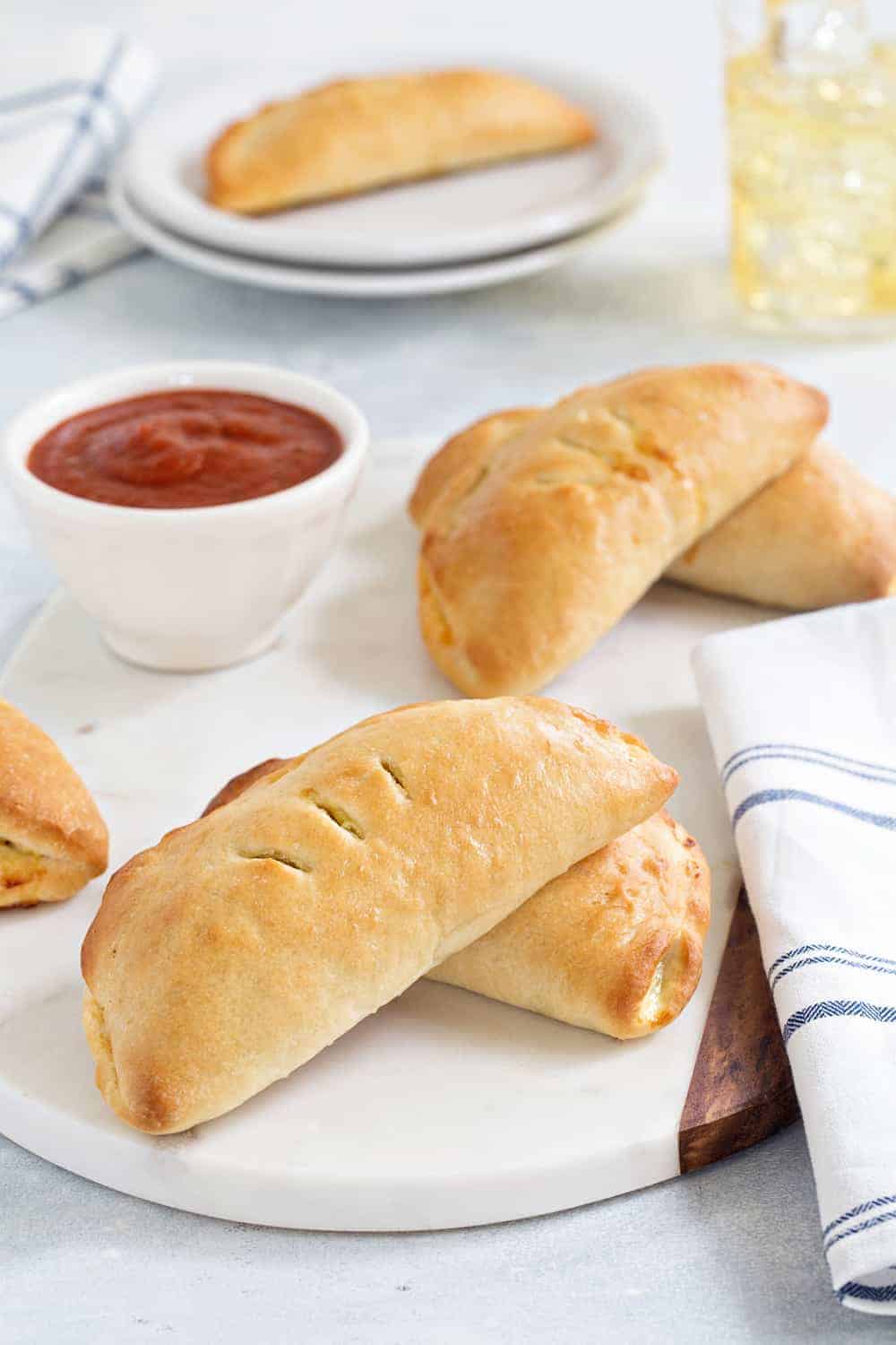 Easy Pizza Pockets come together quickly and are totally delish. Fill them with your favorite pizza toppings for the perfect game day snack!
