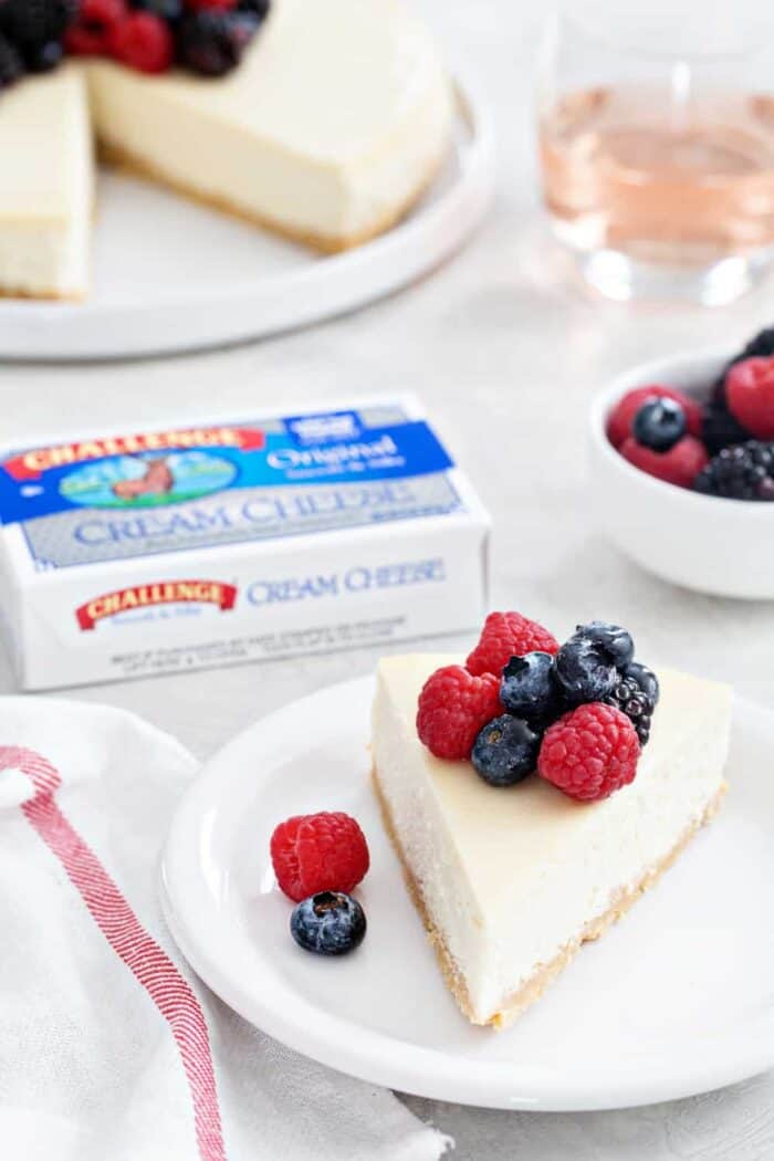 Rosé Cheesecake is rich, creamy, and full of flavor. A sugar cookie crust and rosé soaked berries make it totally irresistible!