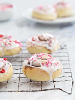 Mini Cinnamon Rolls are a fun and delicious way to celebrate any holiday! A sweet glaze and colorful sprinkles make them extra festive.