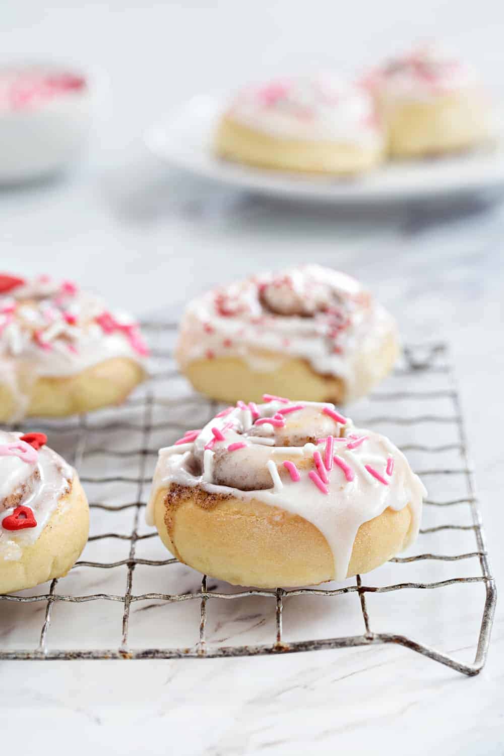 Mini Cinnamon Rolls are a fun and delicious way to celebrate any holiday! A sweet glaze and colorful sprinkles make them extra festive.