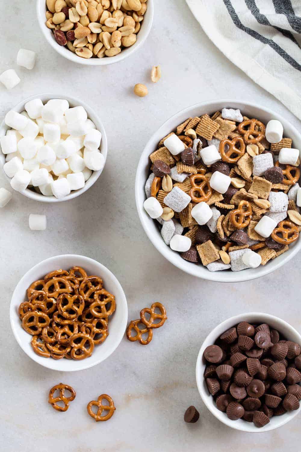 S'mores Snack Mix combines graham cereal, puppy chow, pretzels, peanuts, mini peanut butter cups and marshmallows to create the most amazing snack mix! Sweet, salty and perfectly crunchy!