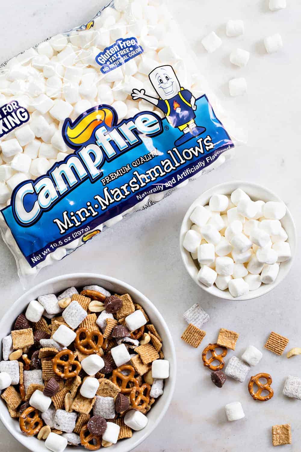 S'mores Snack Mix combines graham cereal, puppy chow, pretzels, peanuts, mini peanut butter cups and marshmallows to create the most amazing snack mix! Simple and totally delicious!