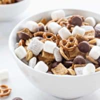S'mores Snack Mix combines graham cereal, puppy chow, pretzels, peanuts, mini peanut butter cups and marshmallows to create the most amazing snack mix! You're going to LOVE it!