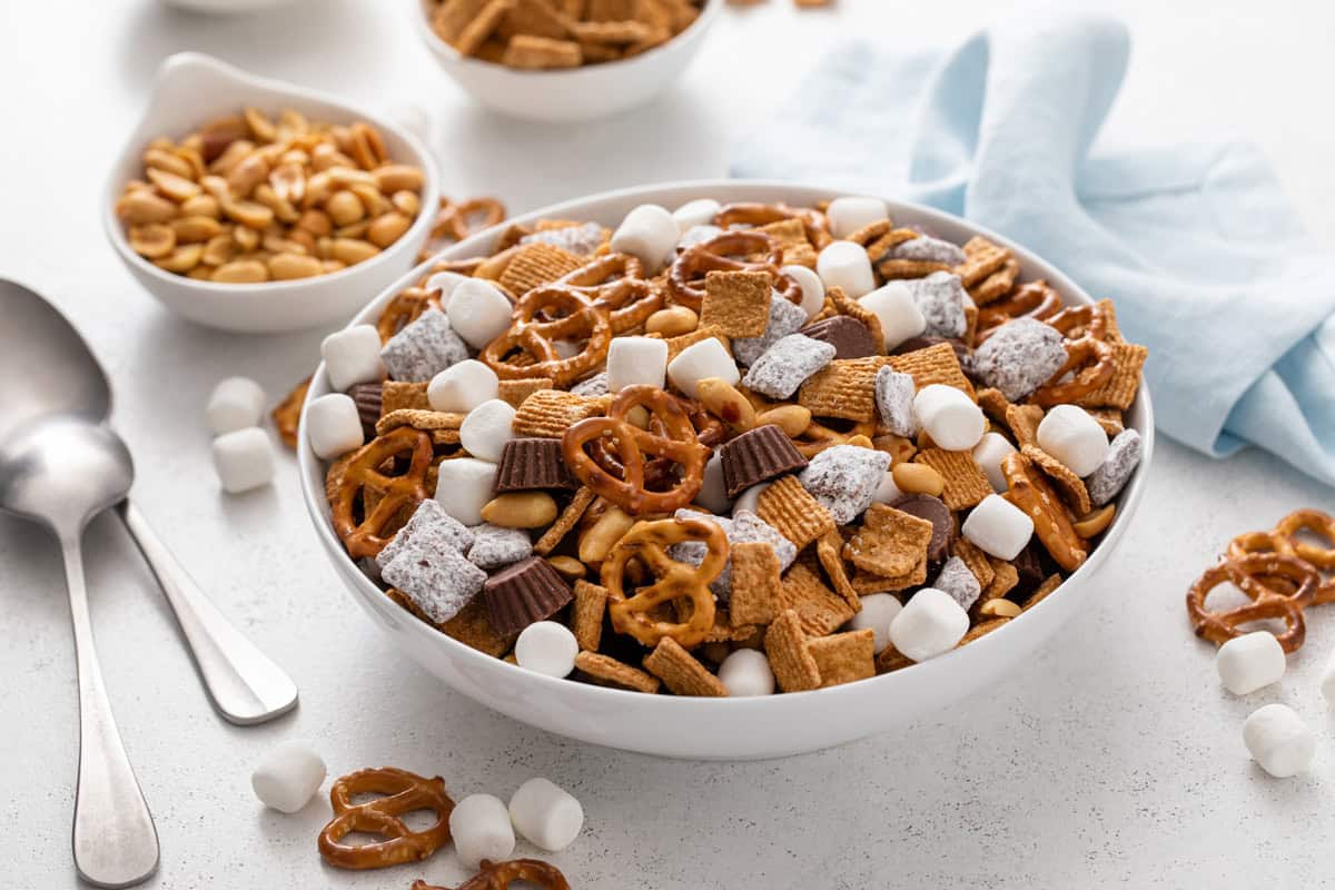 Large white bowl of s'mores trail mix set on a white countertop.