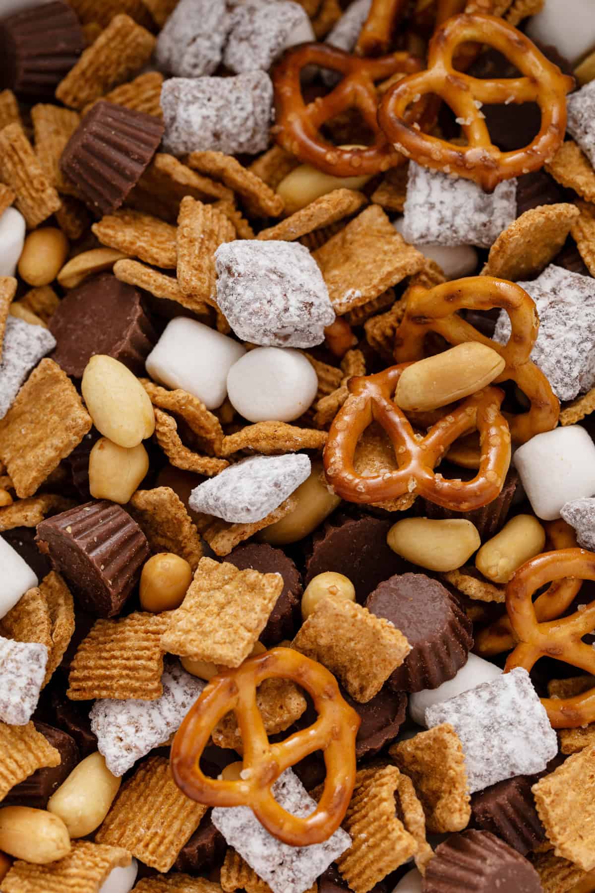 Close up image of the ingredients for s'mores trail mix stirred together.