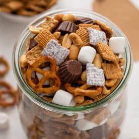 s'mores trail mix in a large glass jar.