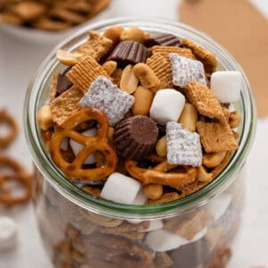 s'mores trail mix in a large glass jar.