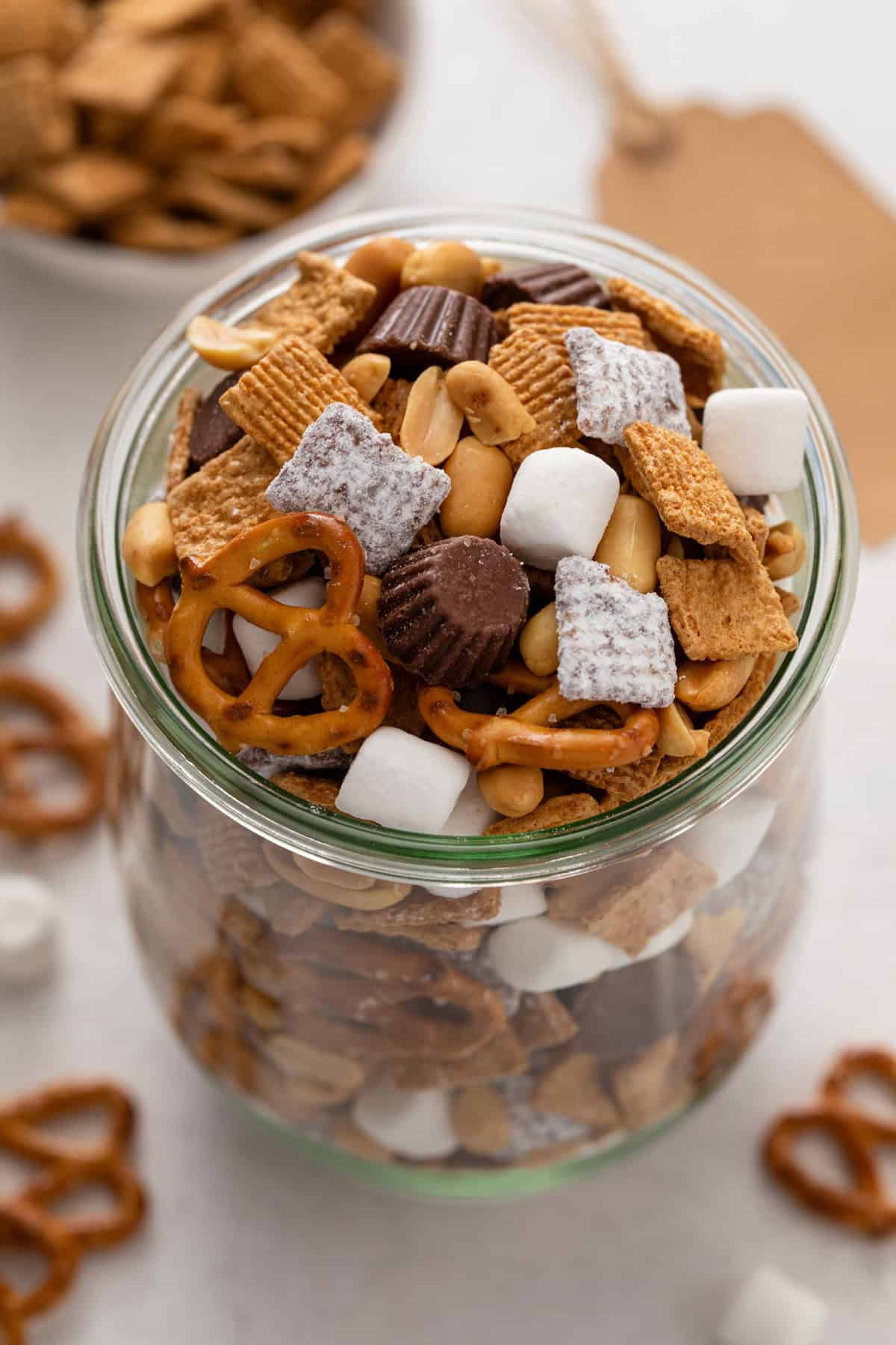 Large glass jar filled to the top with s'mores trail mix.