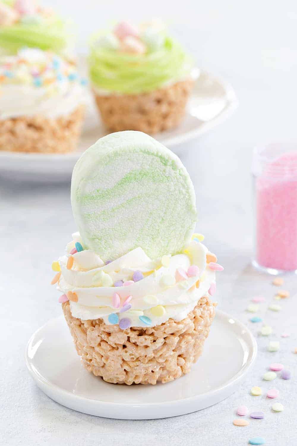 Marshmallow Treat Cupcakes are an adorable and delicious addition to any spring party! Festive sprinkles and colorful marshmallows make them extra special