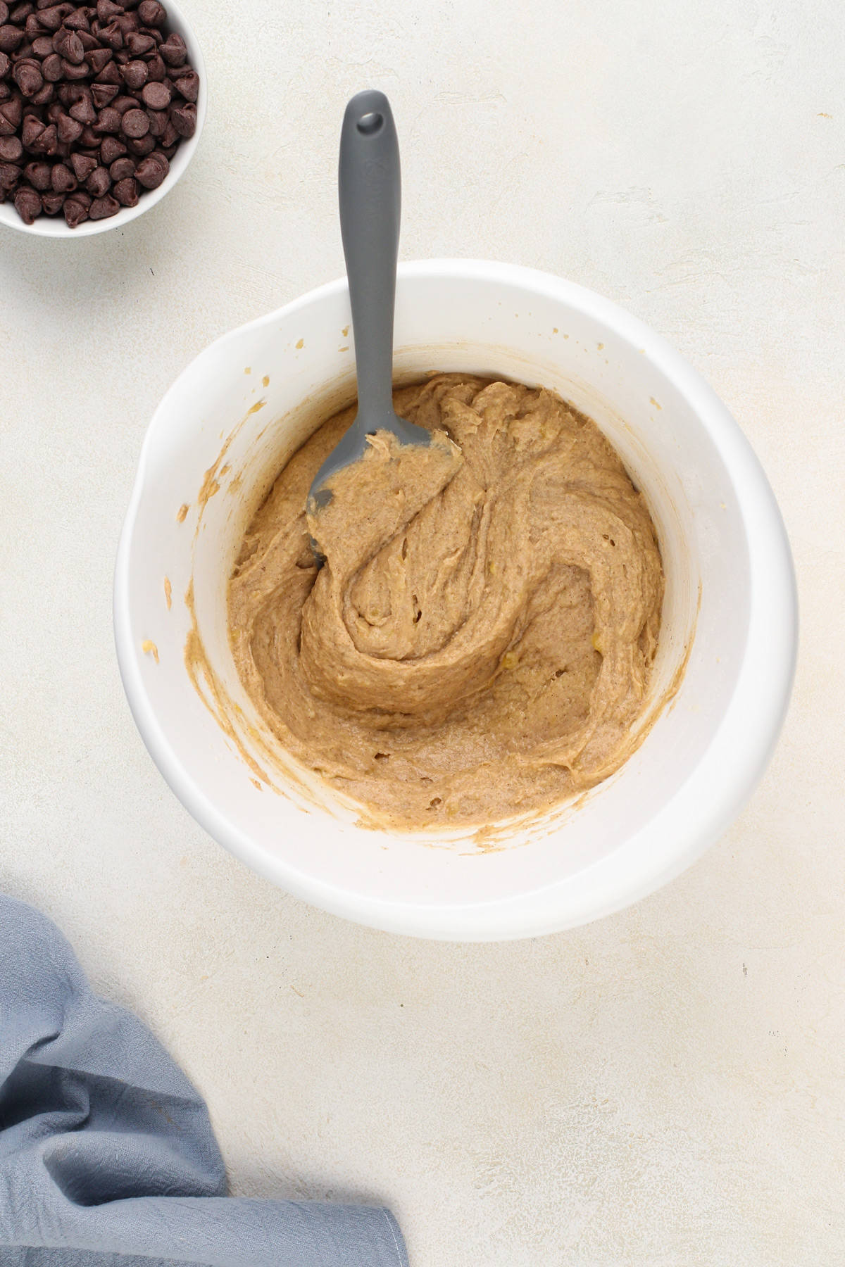 Base for banana oatmeal cookie dough in a white mixing bowl.