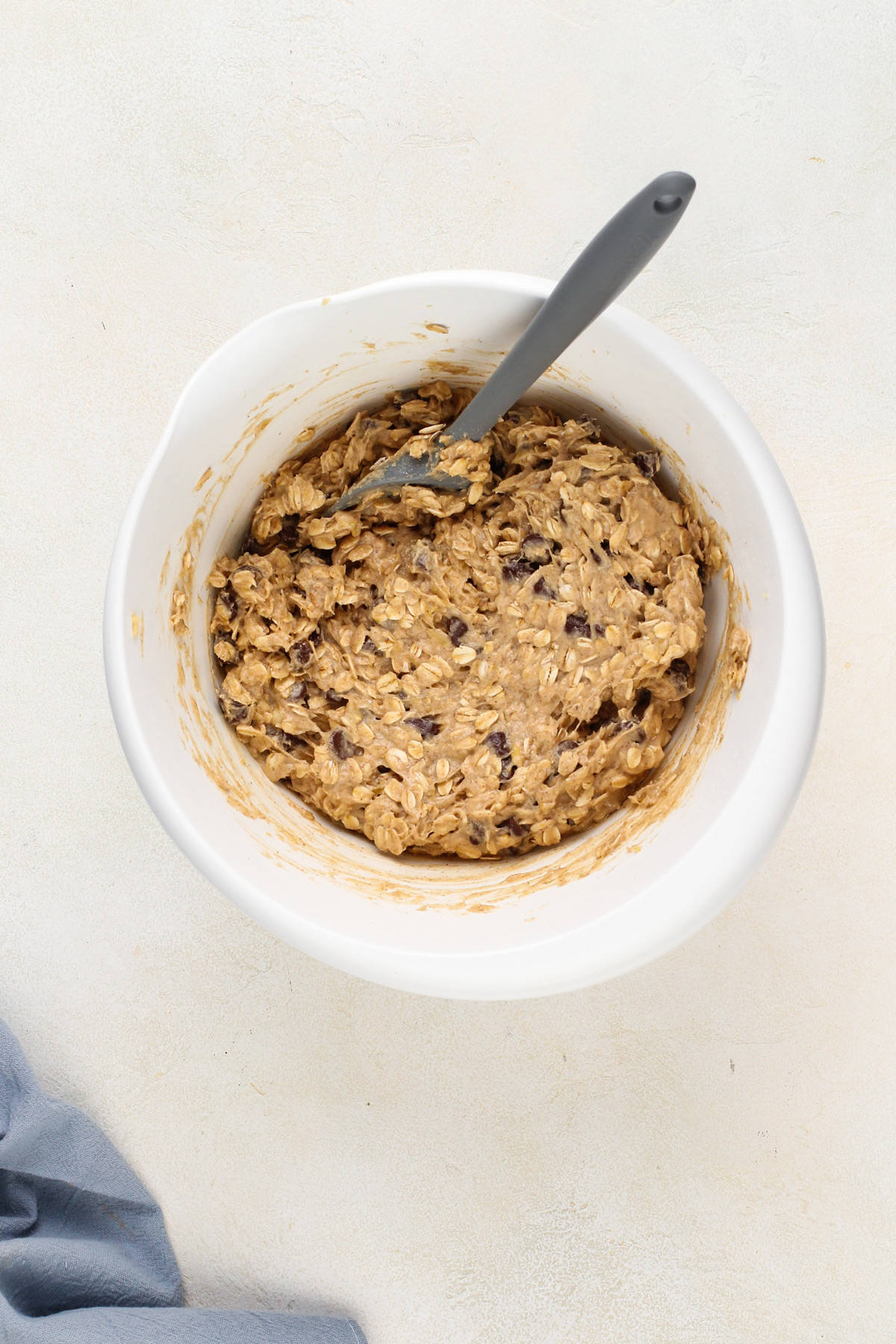 Banana oatmeal cookie dough in a white mixing bowl.