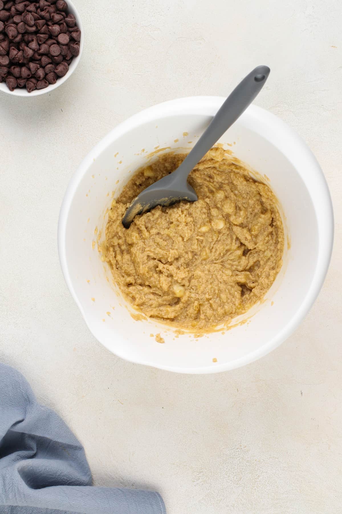 Wet ingredients for banana oatmeal cookies in a white mixing bowl.