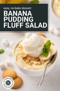 Spoon in a small bowl of banana pudding fluff that's topped with whipped cream. Text overlay includes recipe name.