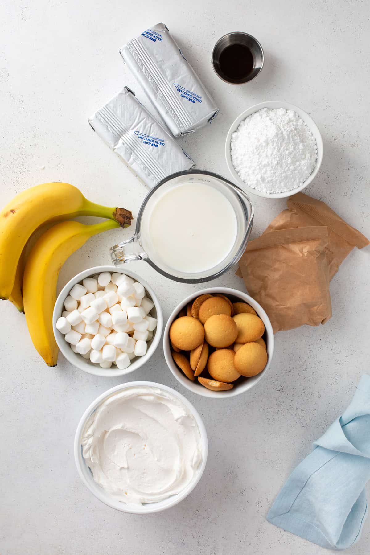 Ingredients for banana pudding fluff arranged on a countertop.