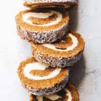 Overhead shot of a sliced pumpkin roll dusted with powdered sugar
