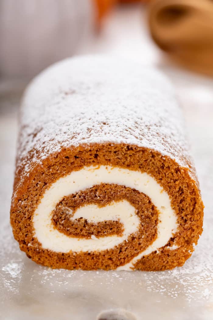 Cross section of a sliced pumpkin roll.