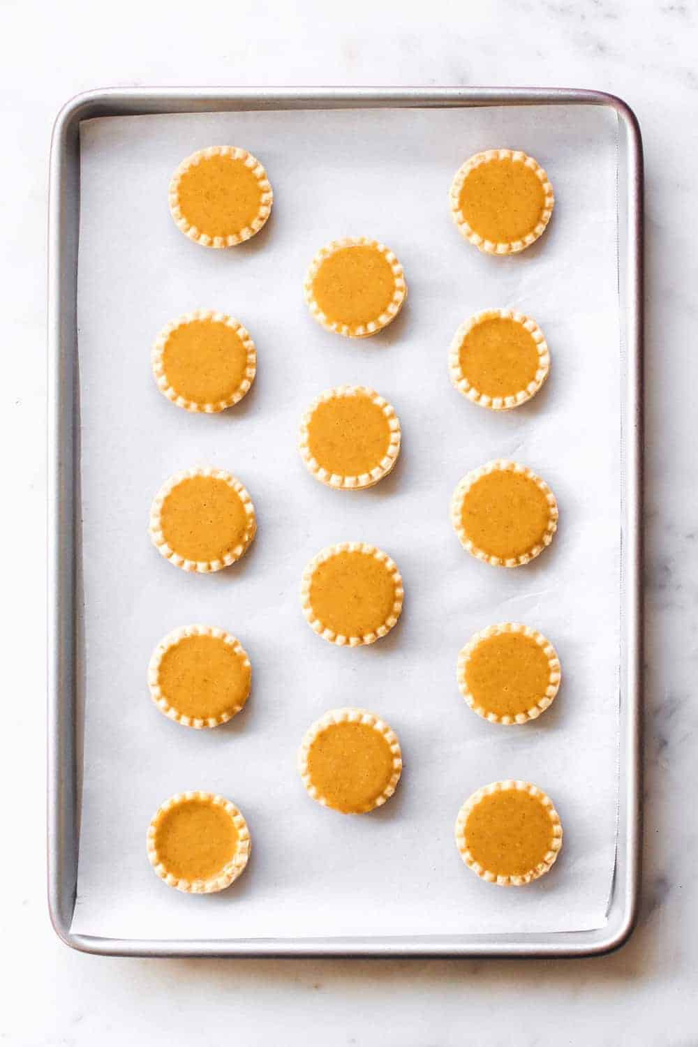 Mini Pumpkin Pies are an entire pumpkin pie in ONE bite! Don't forget the whipped cream!