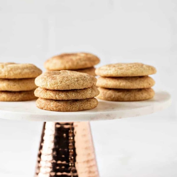 Side view of stacks of snickerdoodle cookies on a marbled cake stand