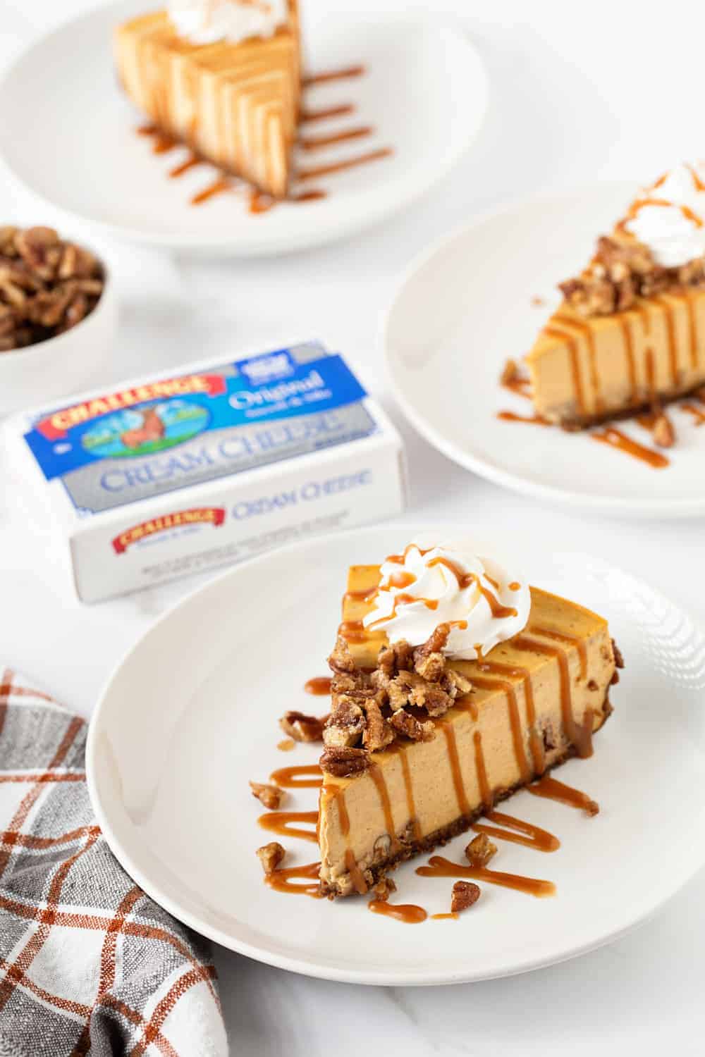 Pumpkin Praline Cheesecake combines sweet praline pecans with creamy pumpkin cheesecake and a gingersnap crust. So perfect for the holidays!