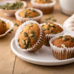 Three pumpkin muffins on a white plate