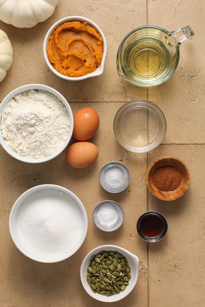 Pumpkin muffin ingredients arranged on a tile counter