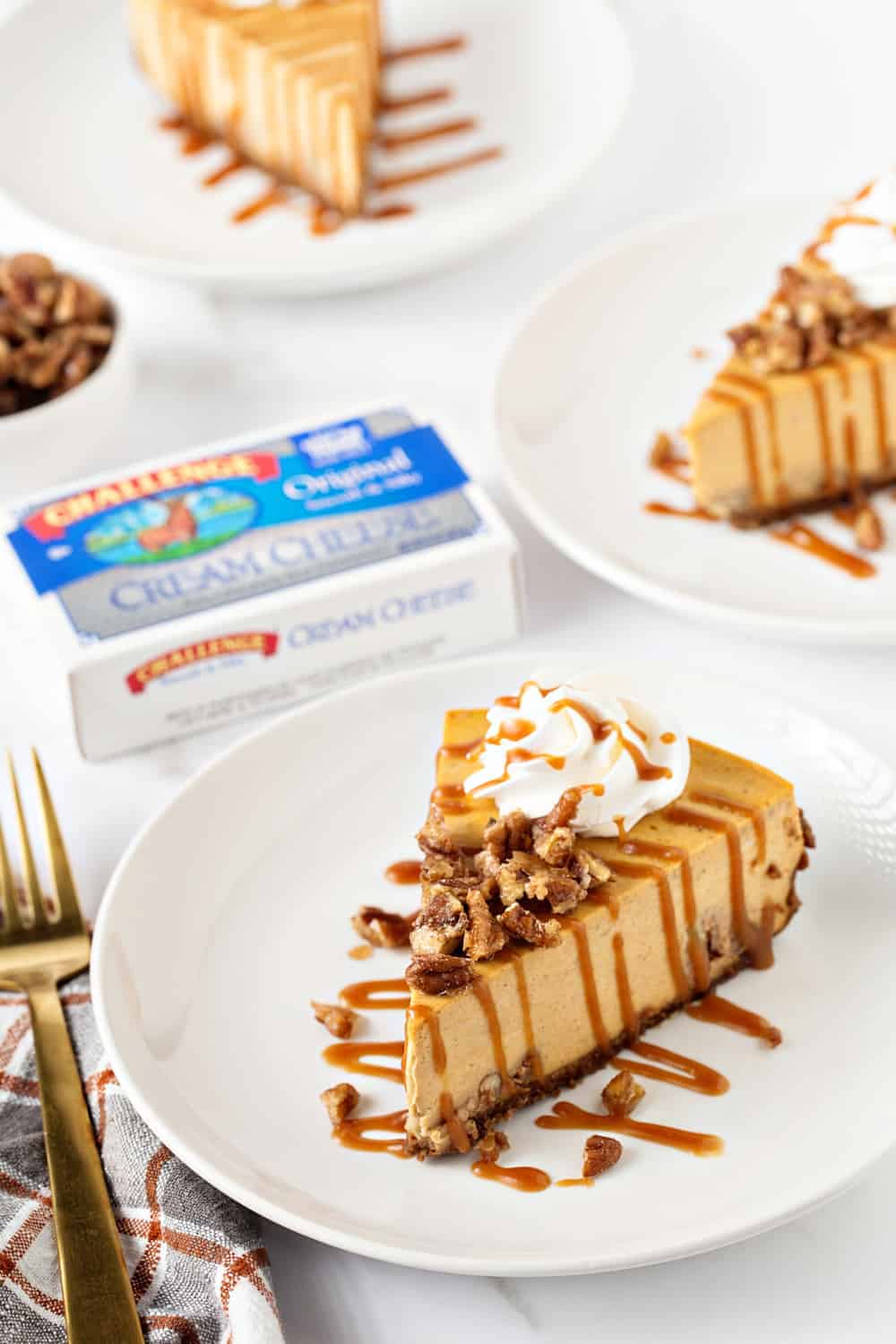 Pumpkin Praline Cheesecake is the perfect dessert for Thanksgiving dinner. It's sweet, creamy and loaded with cozy spices.
