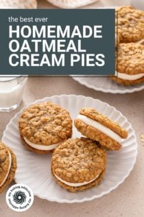 Two white plates filled with homemade oatmeal cream pies next to a glass of milk. Text overlay includes recipe name.