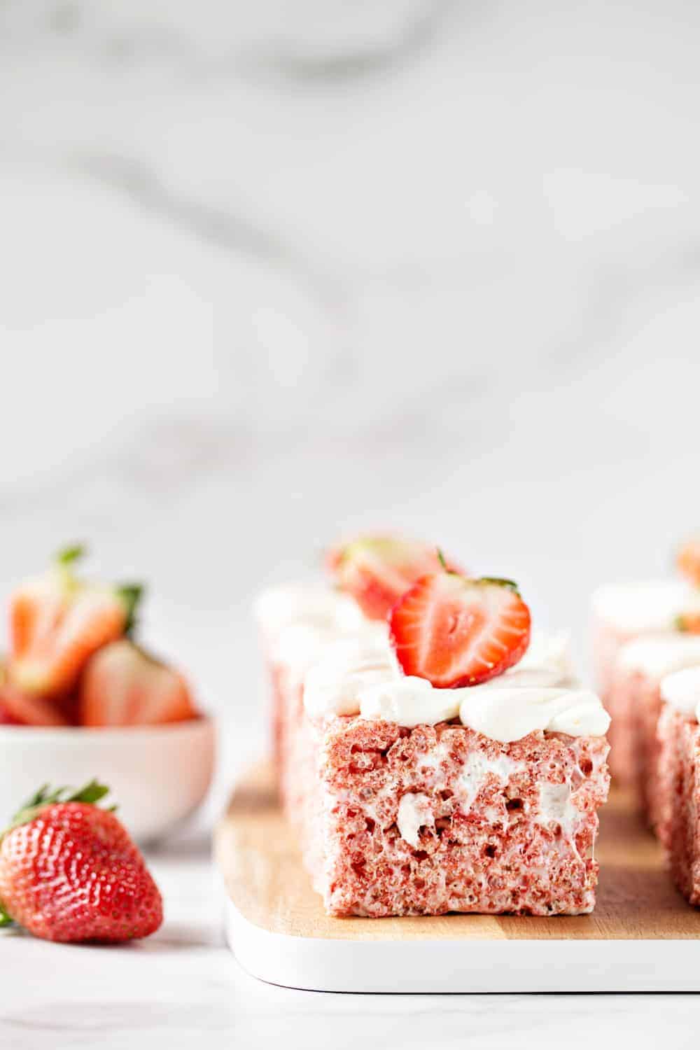 Strawberry Rice Krispie Treats are the perfect simple dessert for Spring. Fluffy vanilla buttercream and fresh strawberries take them to the next level!