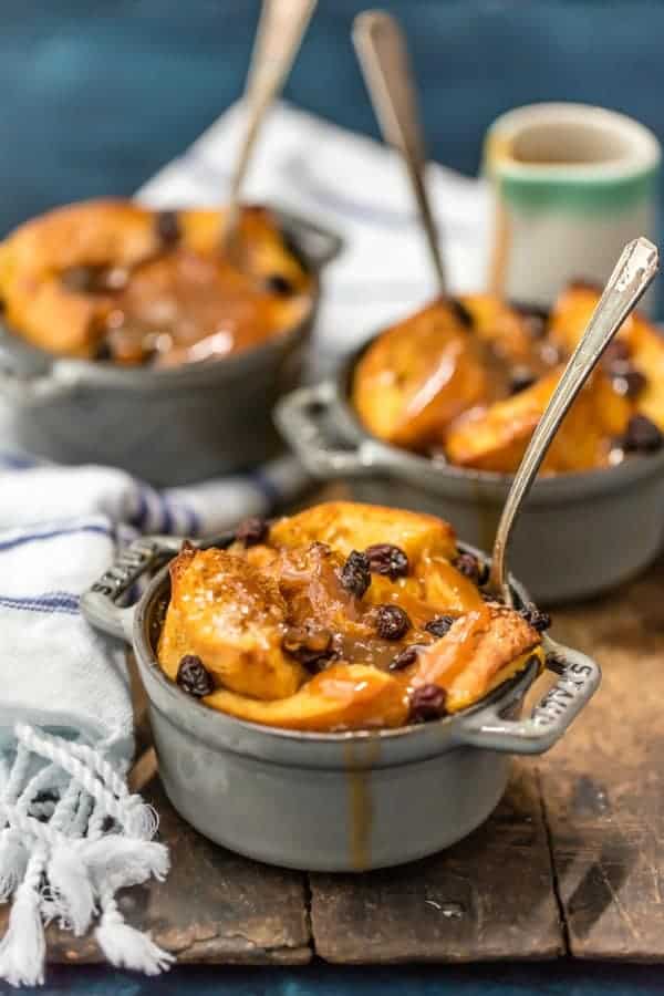 Three ramekins full of irish bread pudding topped with whiskey caramel sauce.