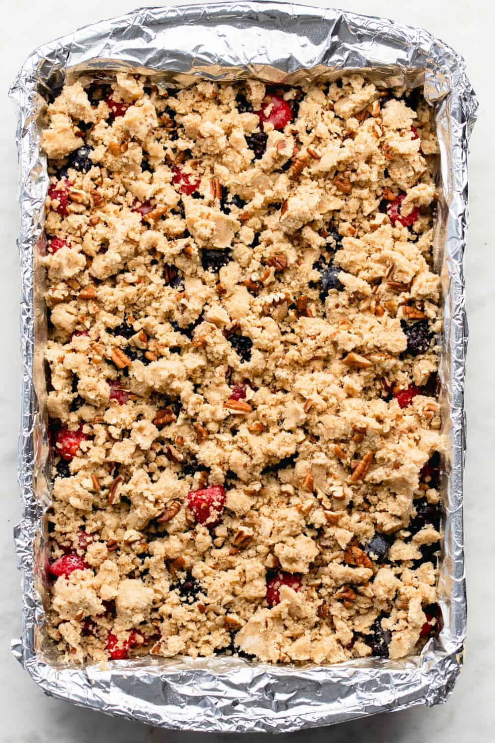Top Berry Crumble Bars with a crumbly topping studded with pecans