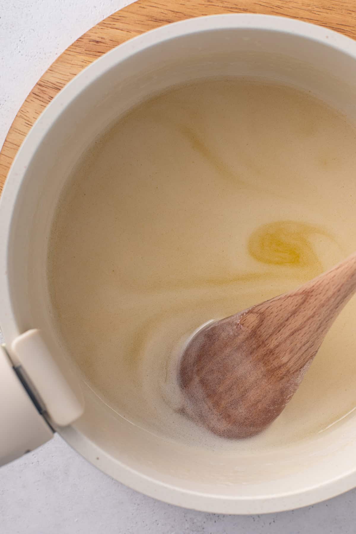 Buttermilk syrup for j alexander's carrot cake heated together in a saucepan.