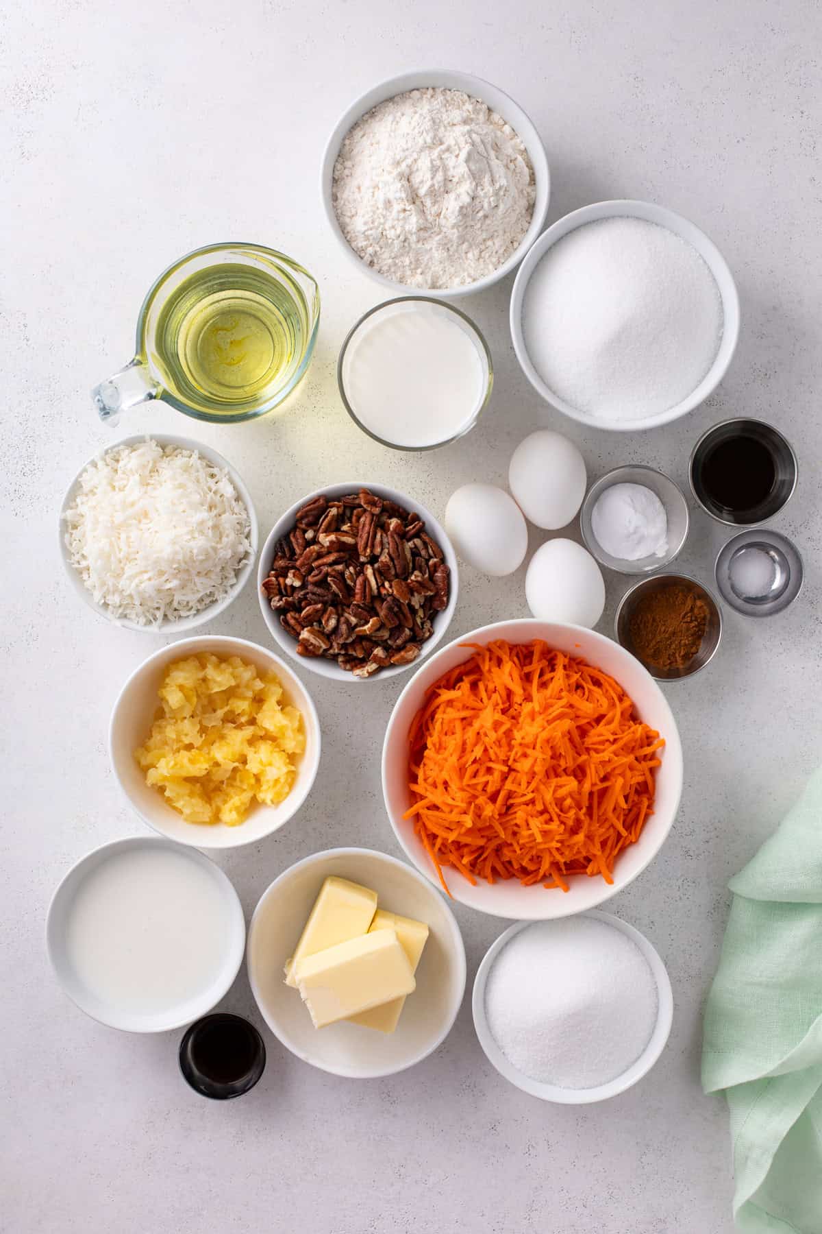 Ingredients for j alexander's carrot cake arranged on a countertop.