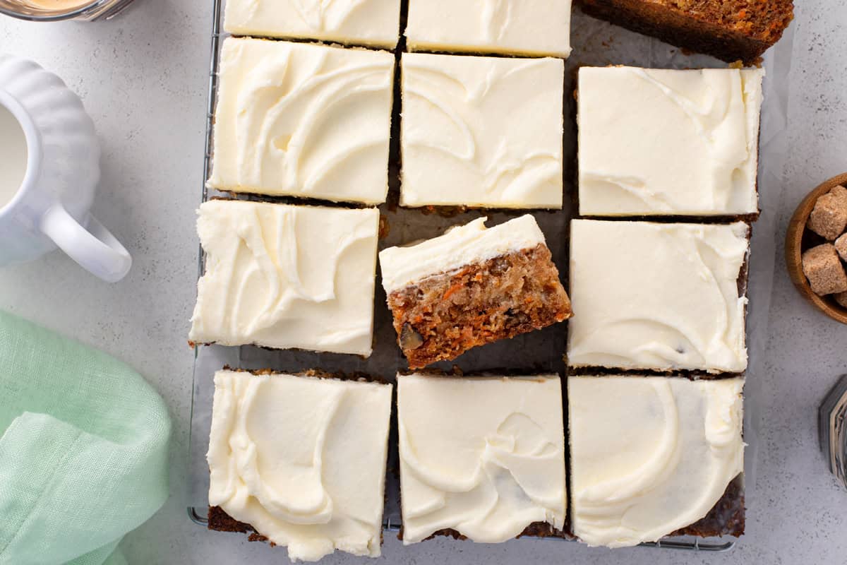 Overhead view of sliced j alexander's carrot cake, with one slice turned on its side.